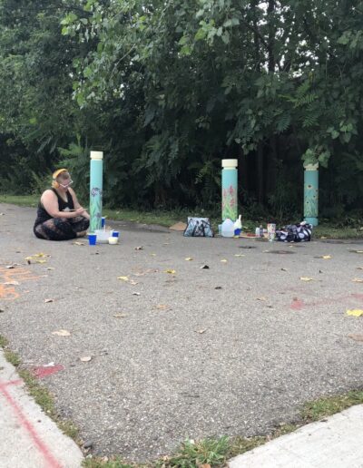 Artist Alain painting their magical designs on the bollards that lead into the Kent Trails.